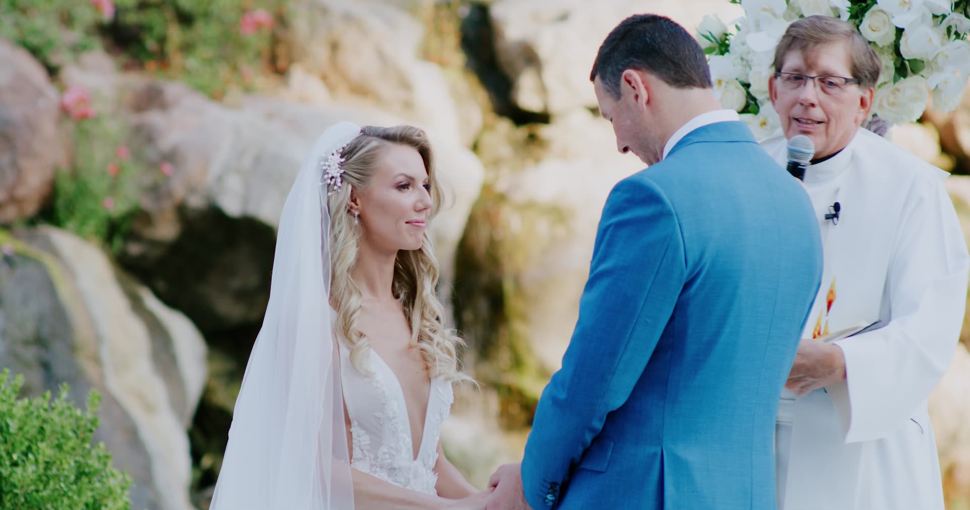 Alano and Alla at the altar beside the waterfall and rock wall at Four Seasons Westlake Village