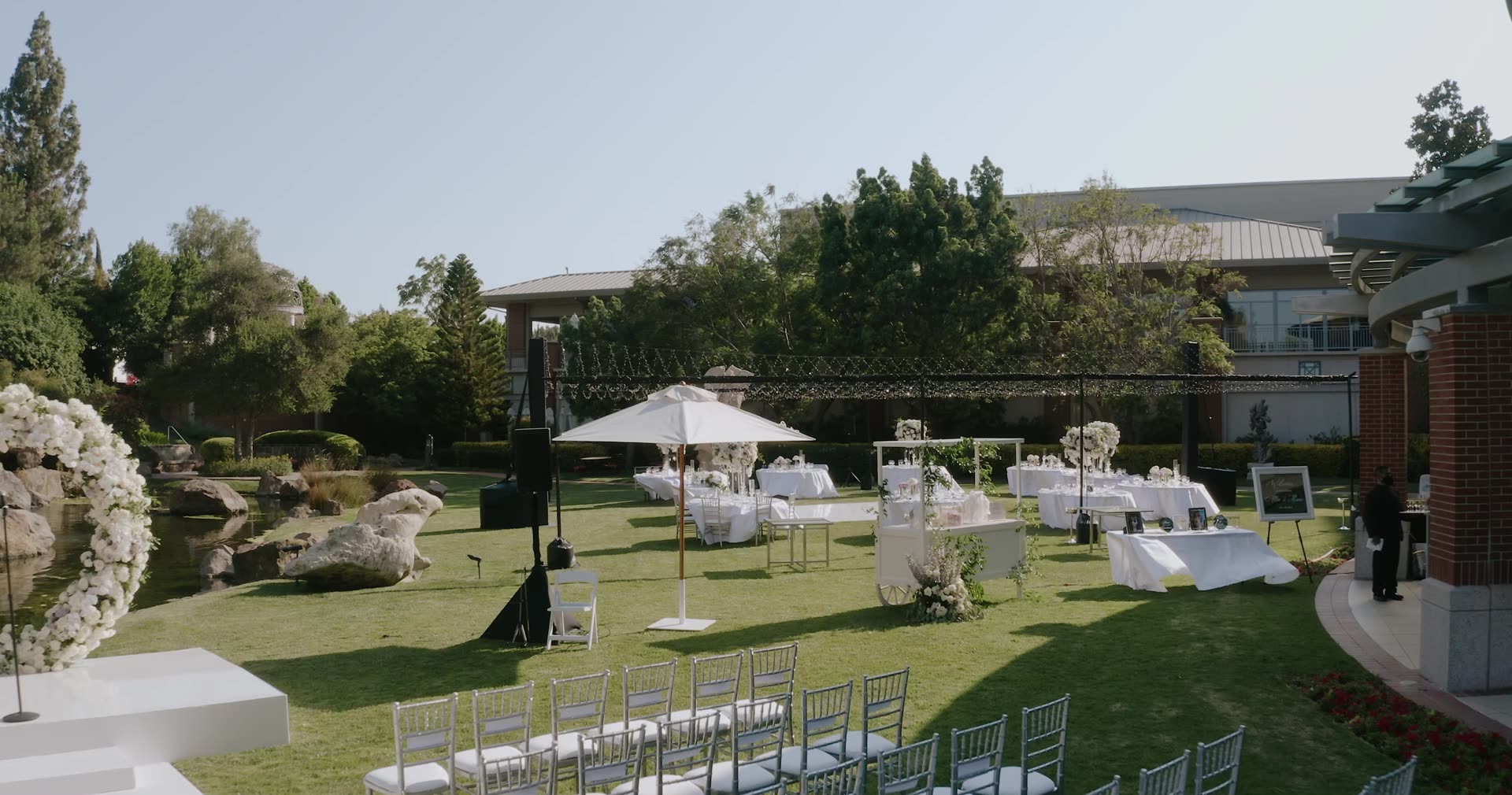 The garden lawn set for a wedding at Four Seasons Westlake Village, with the resort behind