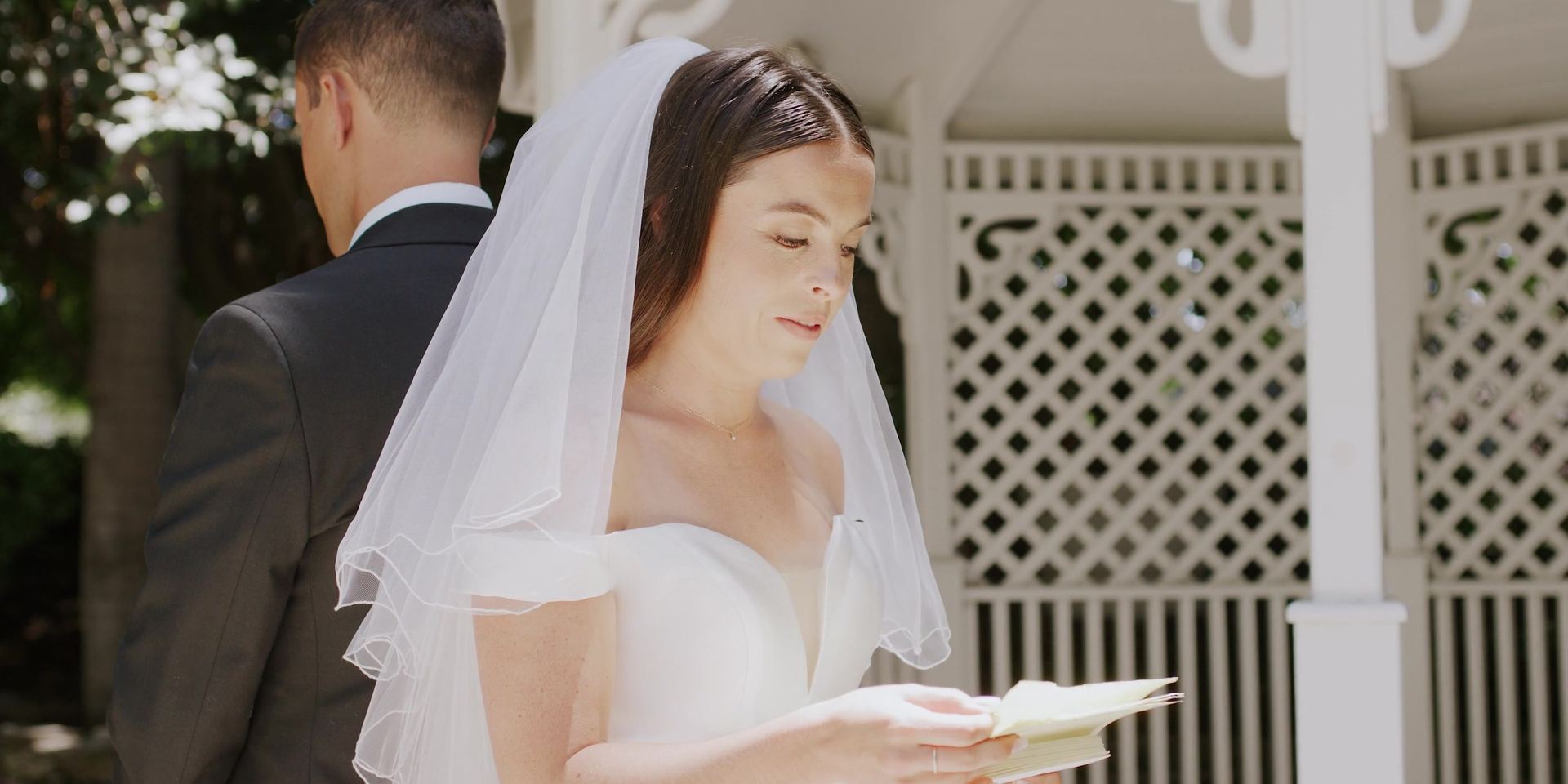Anna reading her vows at the white gazebo.