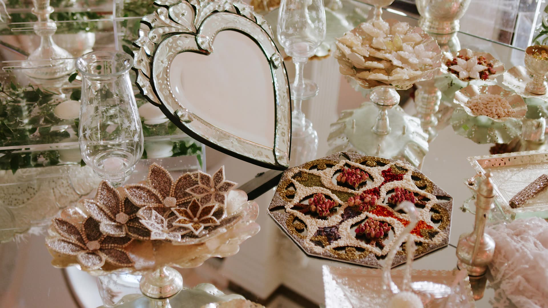 The sofreh aghd laid with mirror, sweets and glassware at Vibiana