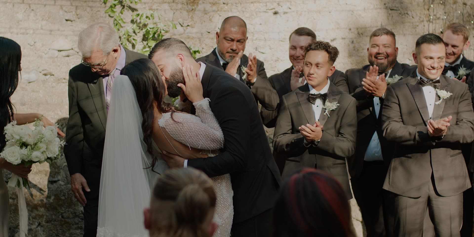 Anthony and Gabi's first kiss as their groomsmen look on in Calistoga