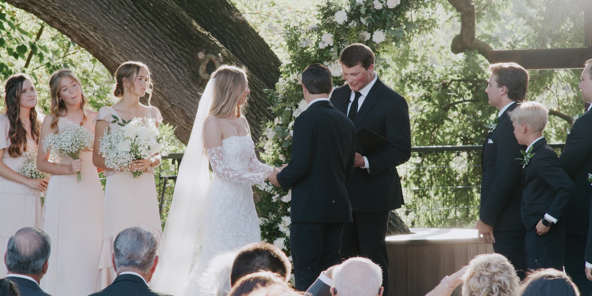 Anna and Jett exchanging vows under the oak in Kingsburg