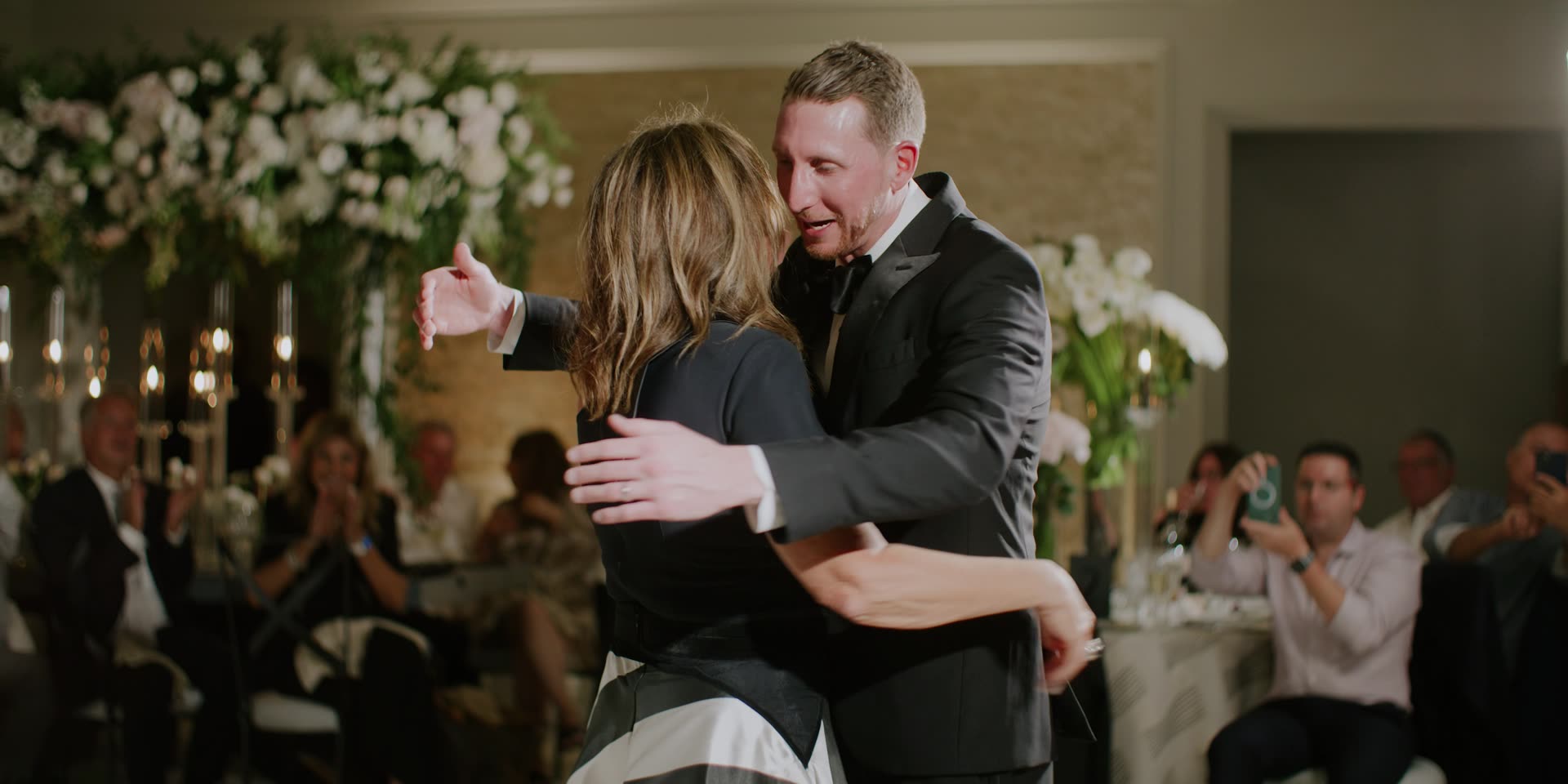 Adam and Laura during their first dance under florals at The Ritz-Carlton, Laguna Niguel