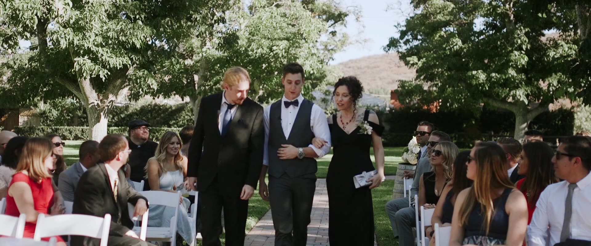The processional beneath the oaks as guests look on at Westlake Village Inn