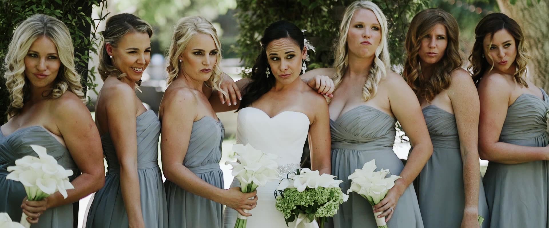 Lindsay with her bridesmaids in sage green on the lawn at Westlake Village Inn