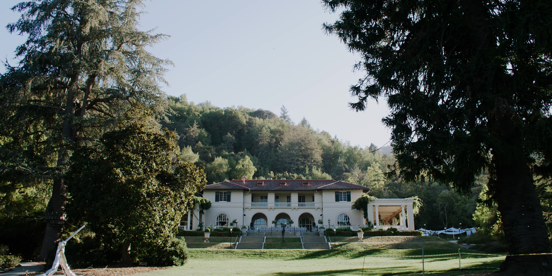 The villa seen across the lawn through the trees at Villa Montalvo
