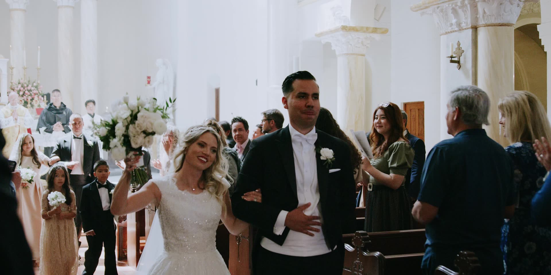 Anthony and Sloane's recessional through the white chapel at Terranea Resort