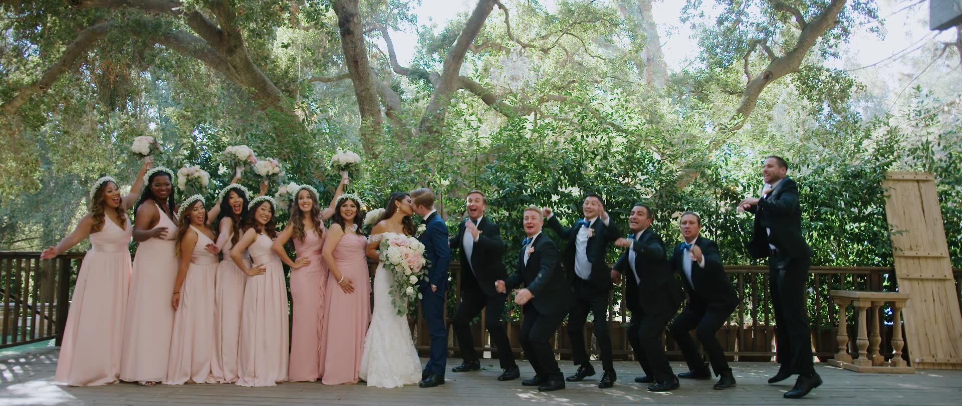 Ben and Catherine with their full wedding party beneath the oaks at Calamigos Ranch