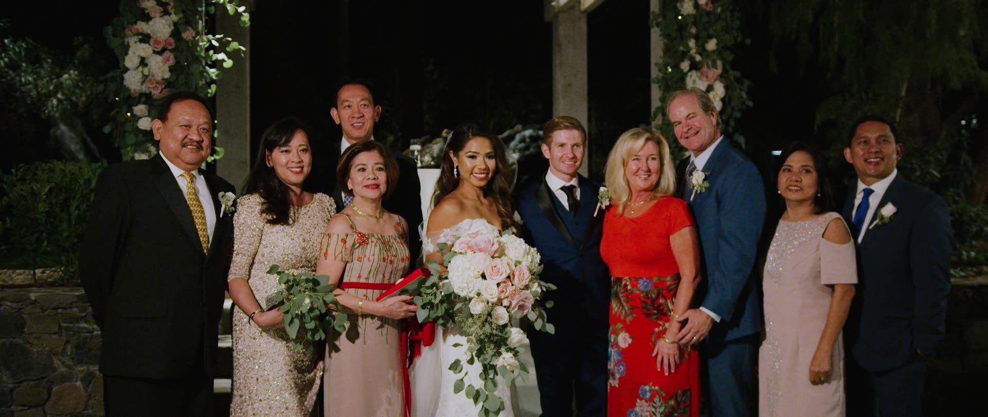 A family portrait beneath the flowered pergola at Calamigos Ranch