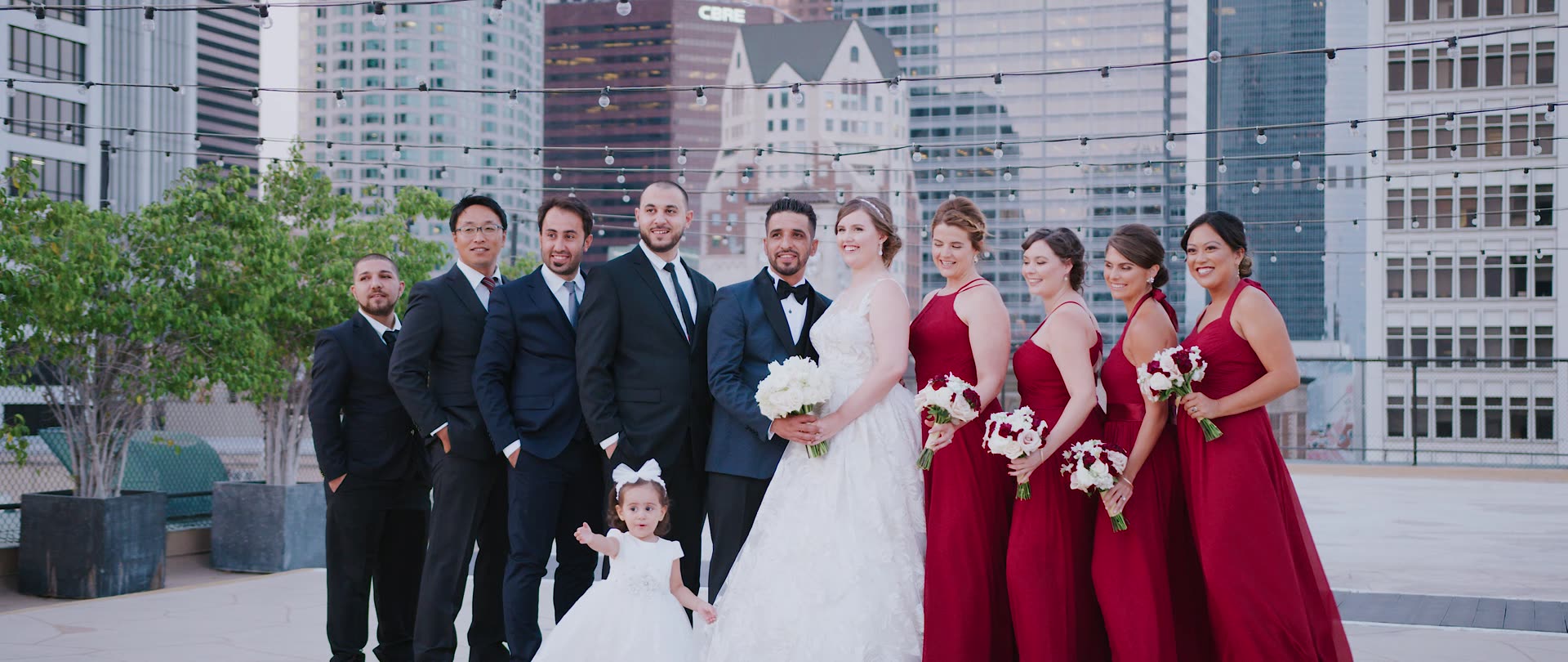 The wedding party on the rooftop with the downtown skyline behind them at the Los Angeles Athletic Club