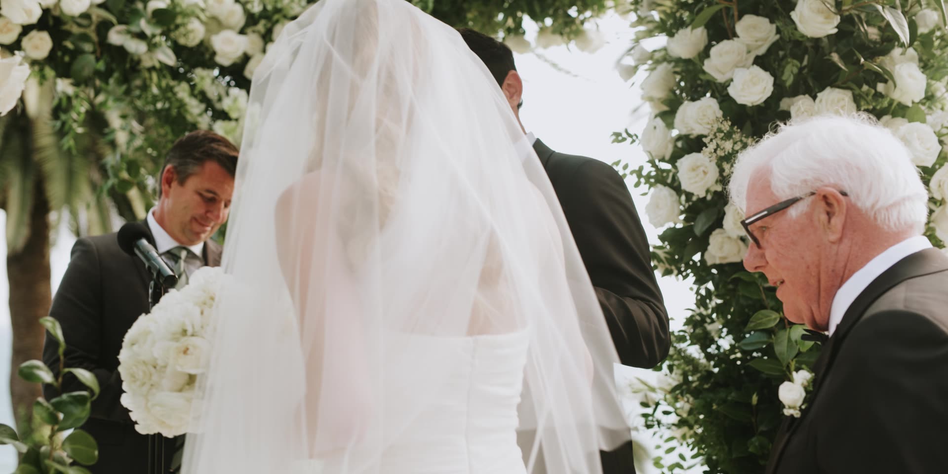 The processional down the white floral aisle above the ocean at Bel-Air Bay Club