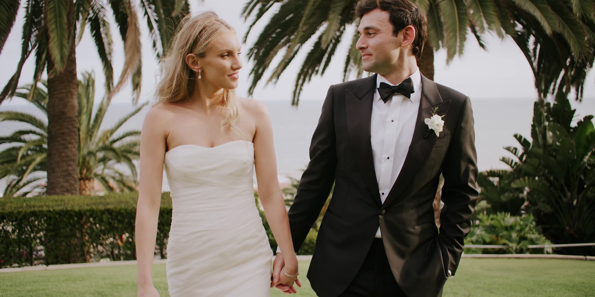 Brennan and Meghan at the altar beneath the floral arch at Bel-Air Bay Club