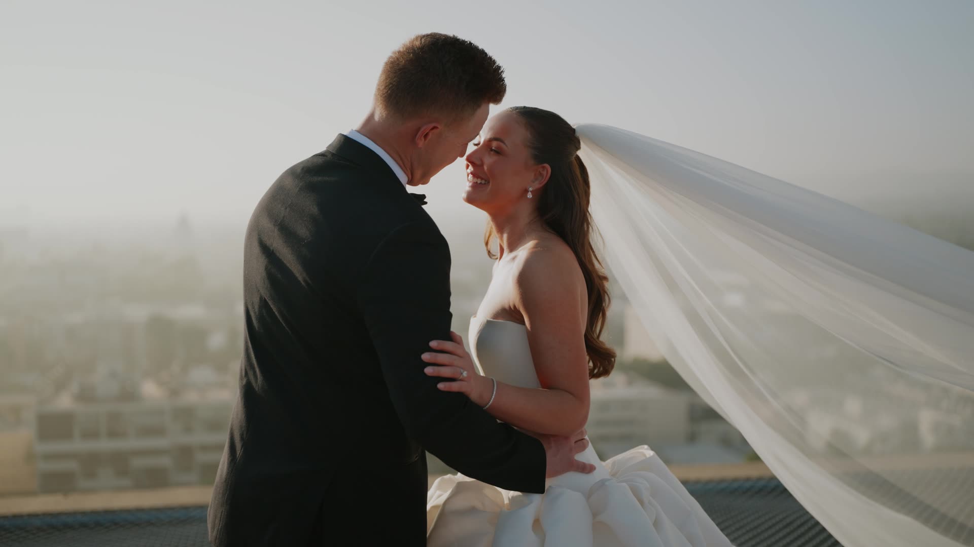 Brian and Ryan together with a veil lifting and the Los Angeles skyline behind them at Four Seasons Los Angeles