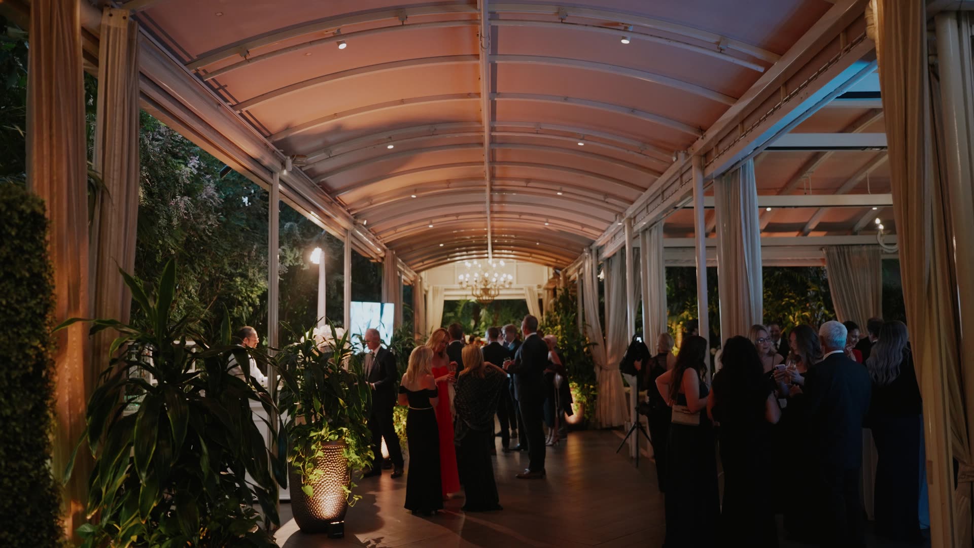The covered terrace at Four Seasons Los Angeles lit for the evening