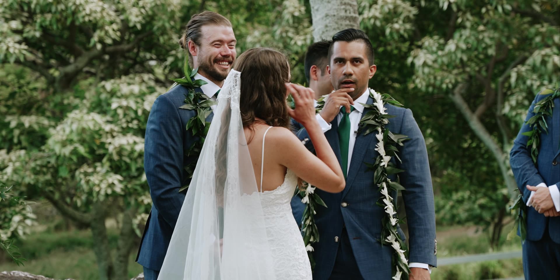 Chris and Bryn wearing maile leis after the ceremony at Kualoa Ranch