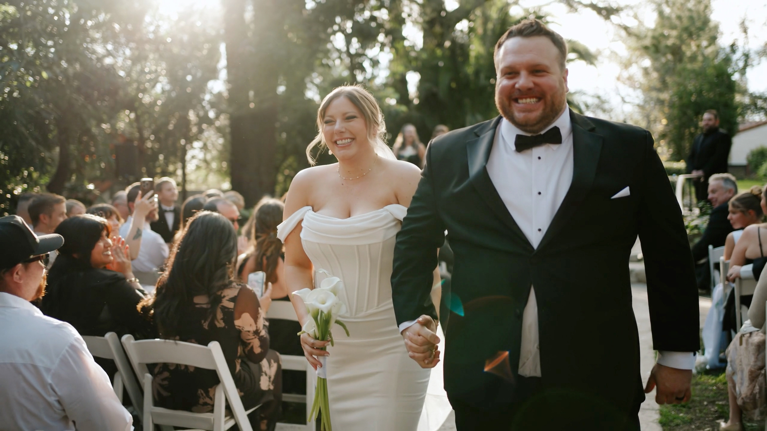 Chris and Emily walking back up the aisle hand in hand after their ceremony at Hidden Oaks Retreat Center