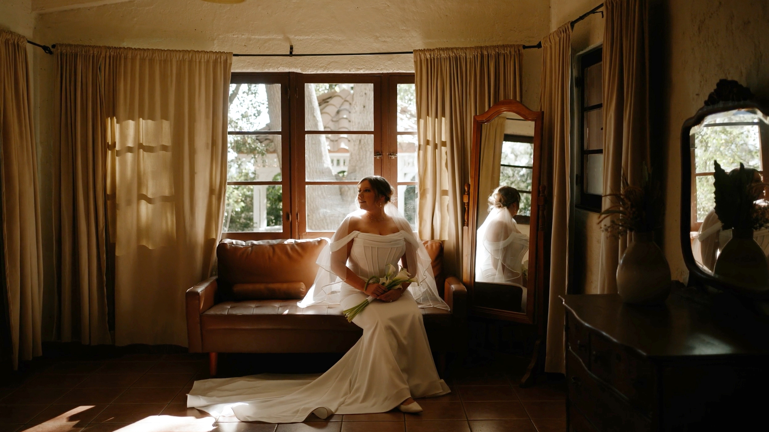 Emily seated by the window in the historic residence at Hidden Oaks Retreat Center