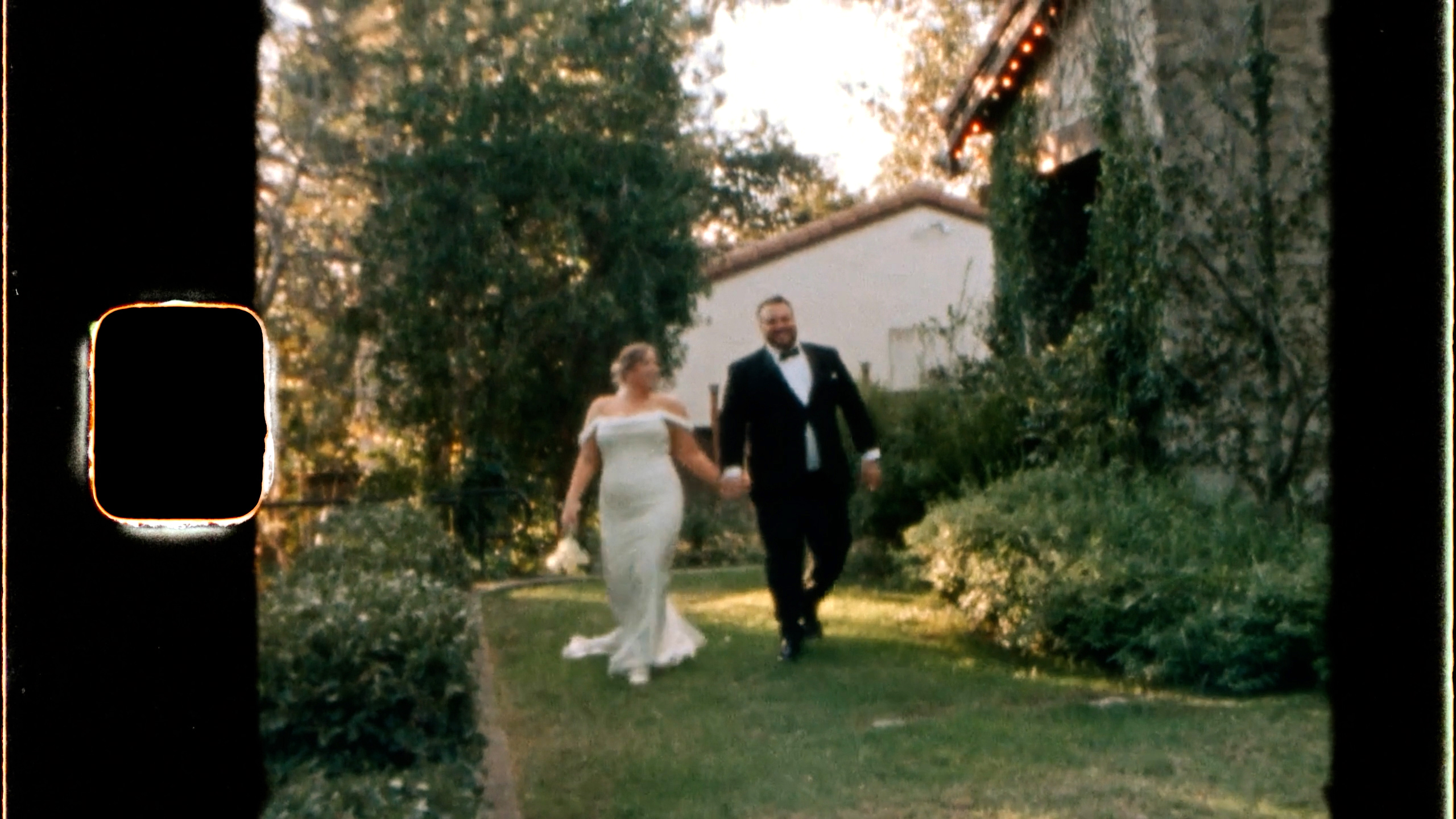 Chris and Emily crossing the lawn at Hidden Oaks Retreat Center, shot on Super 8