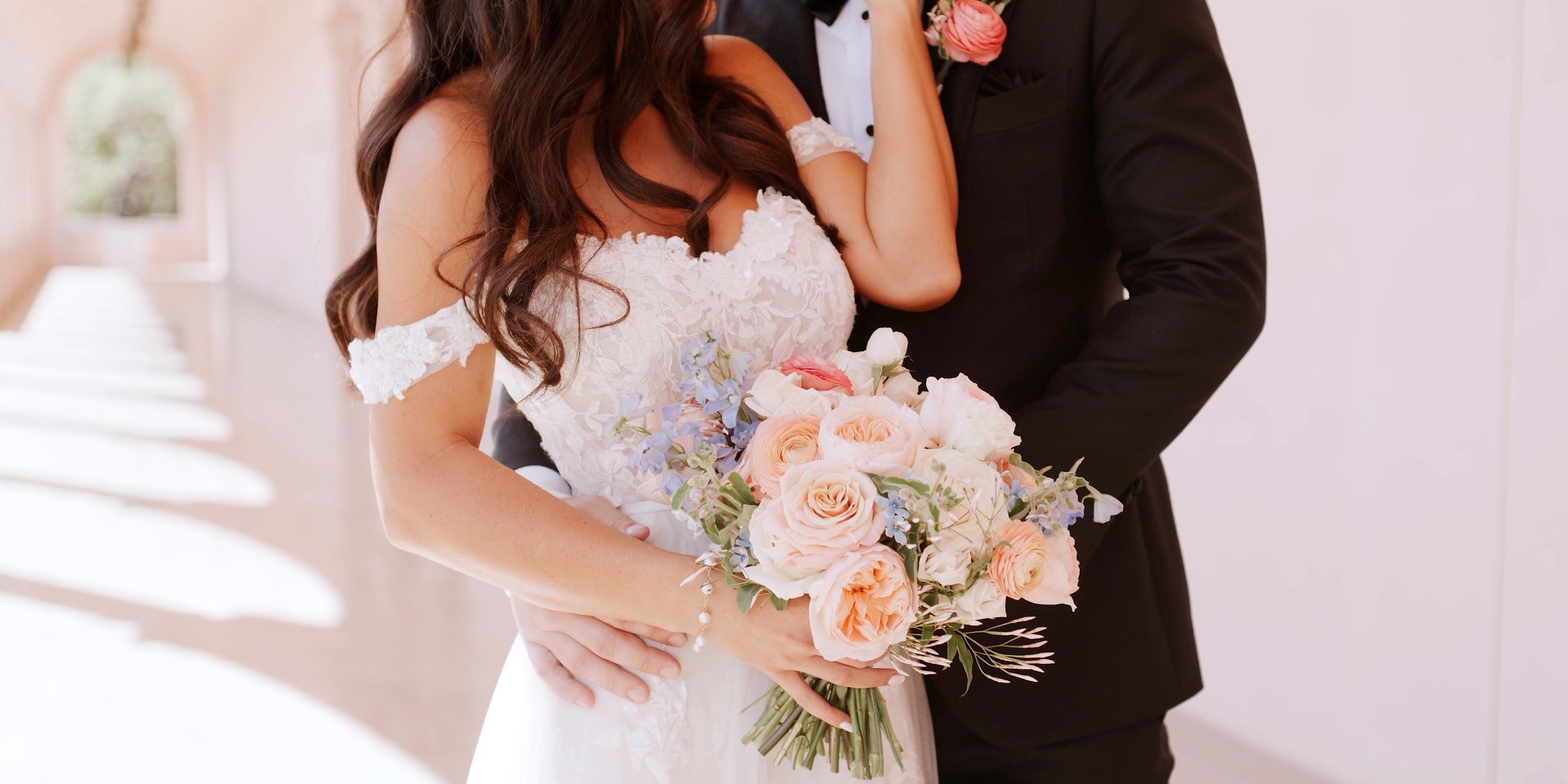 Bride's peach garden rose and blue delphinium bouquet at a Ca d'Zan wedding in Sarasota