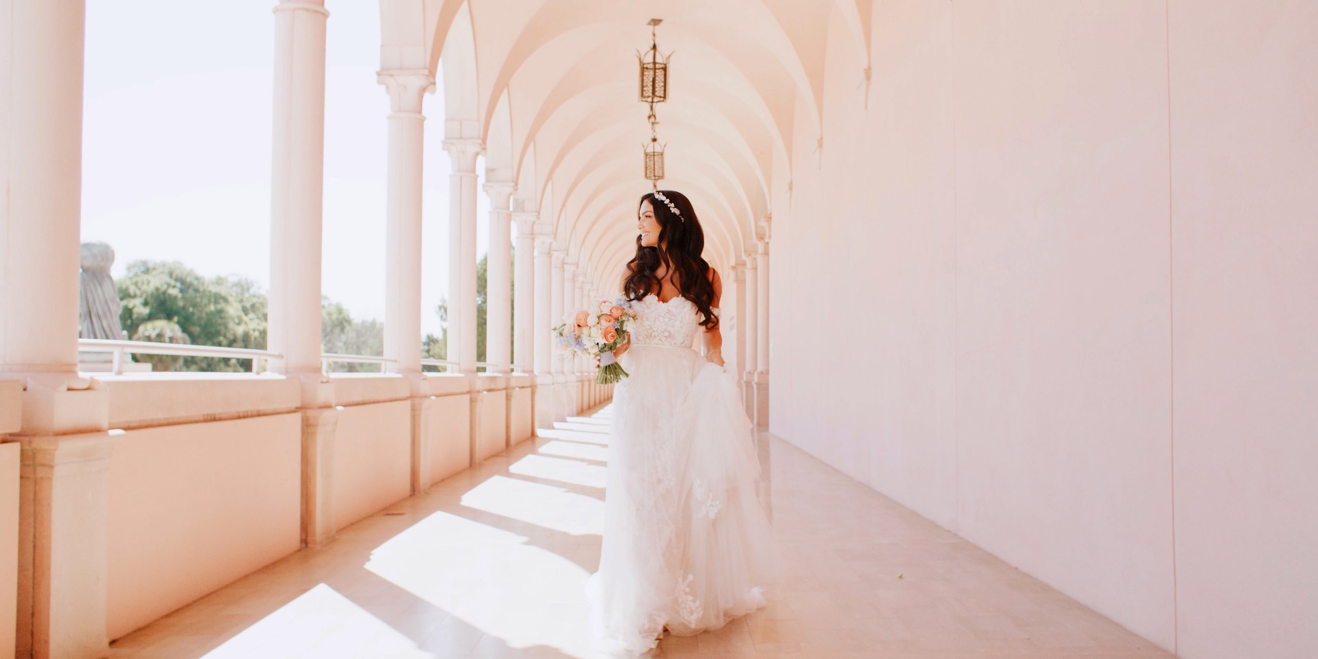 Bride in the pink arched colonnade at The Ringling Museum in Sarasota, Florida