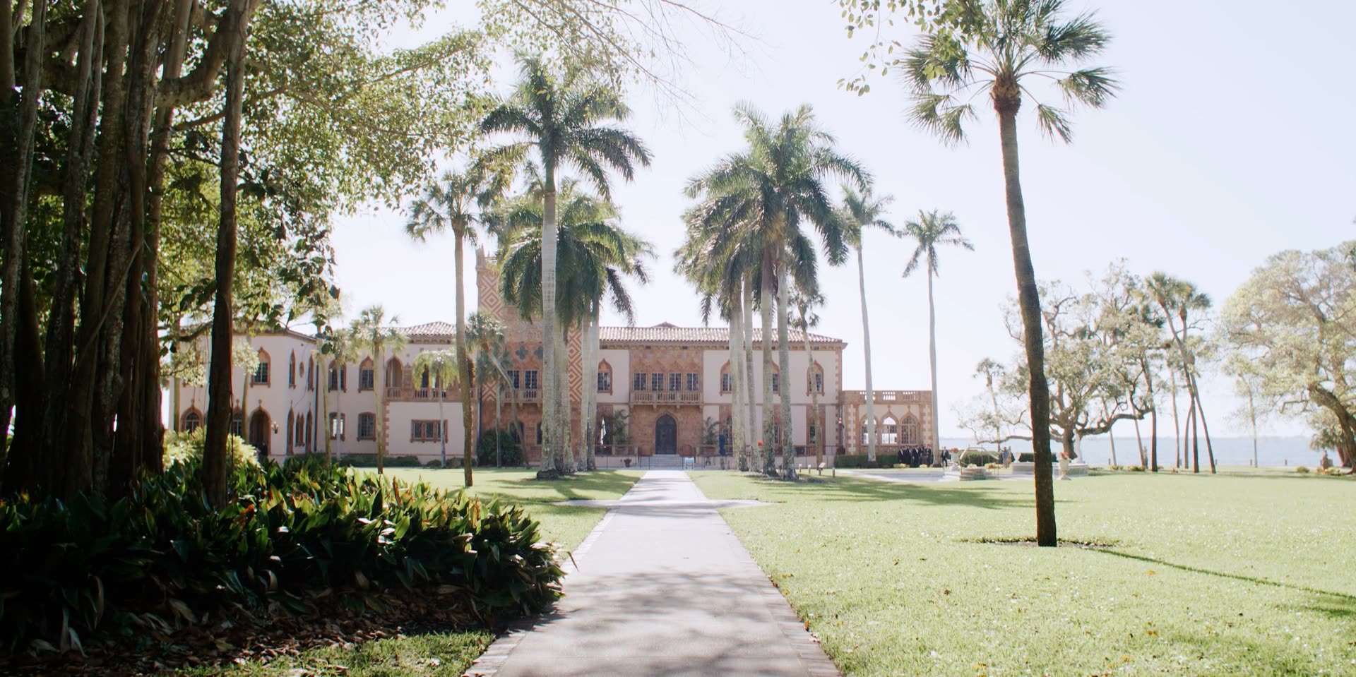 Ca d'Zan, the Venetian Gothic mansion at The Ringling in Sarasota, Florida, framed by palms on the bayfront lawn