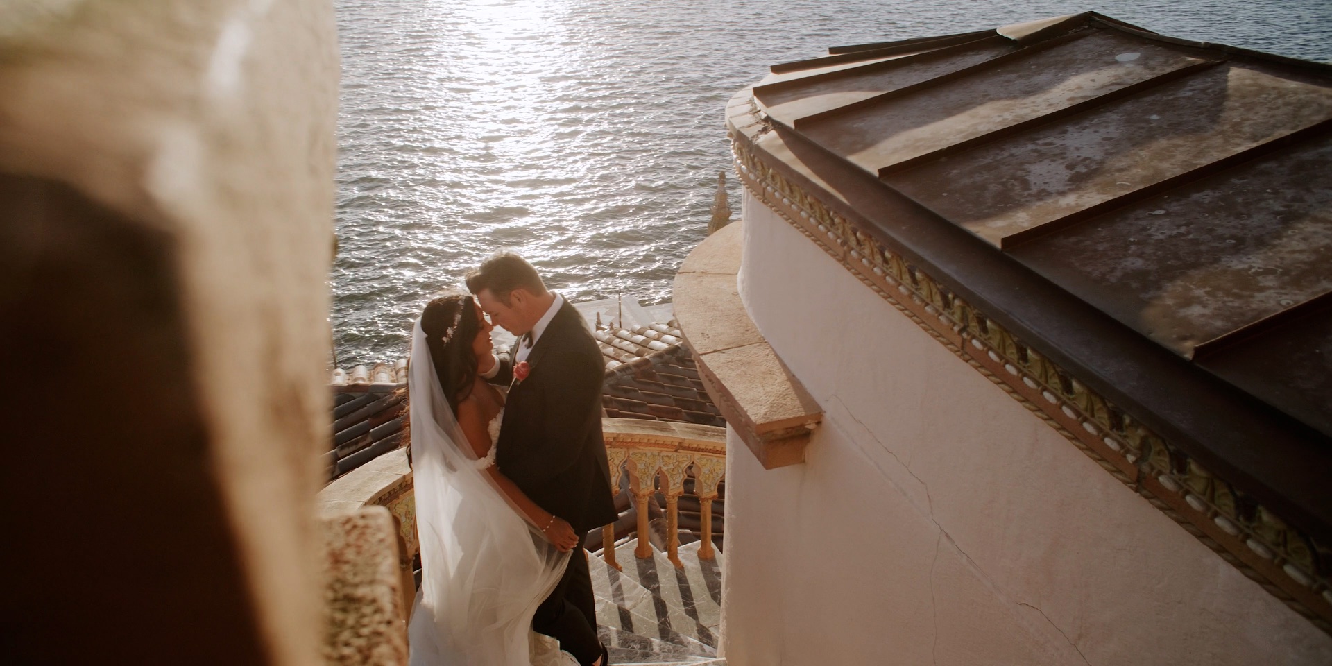 Bride and groom on the terrace stairs at Ca d'Zan overlooking Sarasota Bay