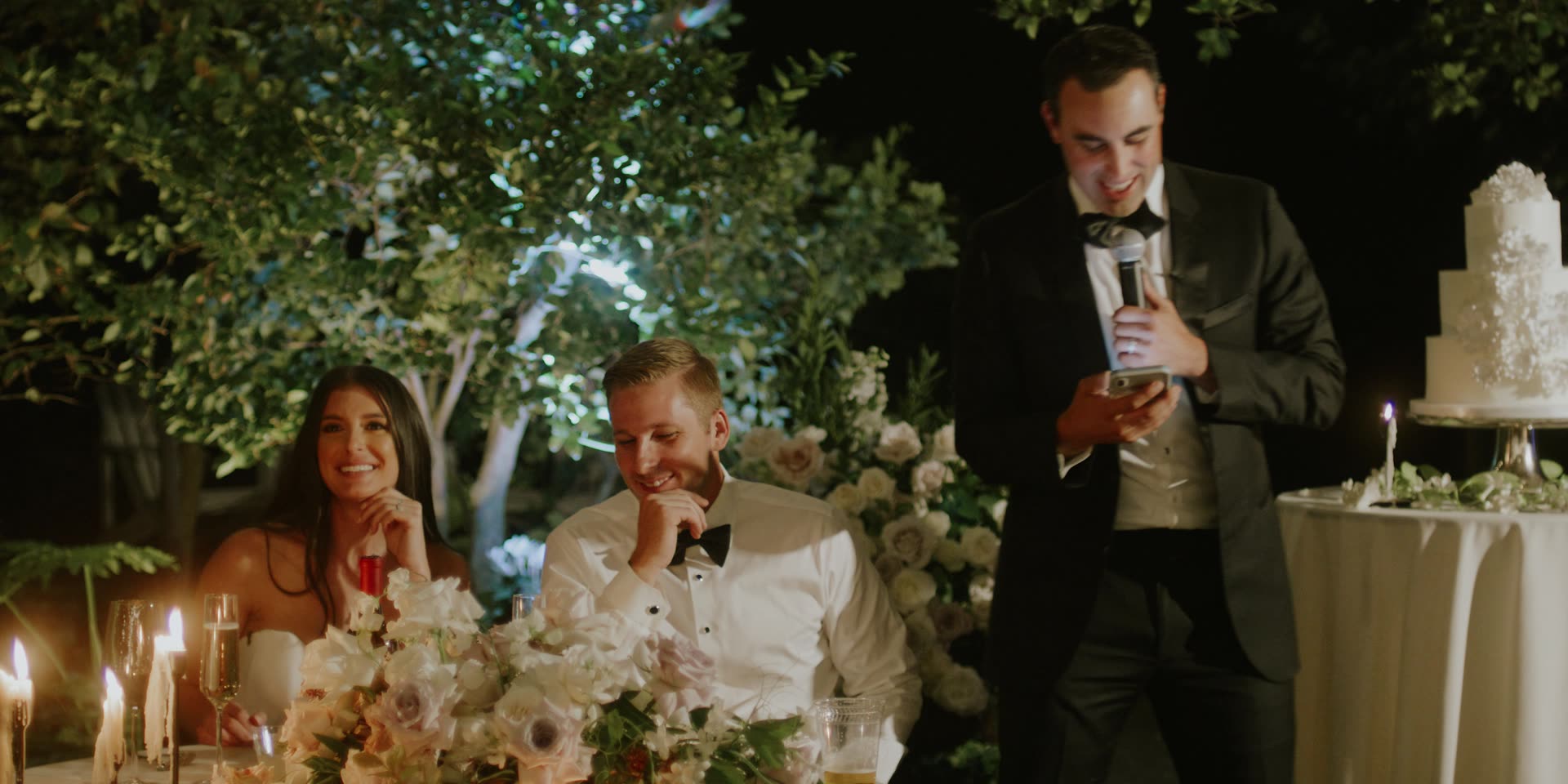 The sweetheart table lit by candles during the reception in Kingsburg