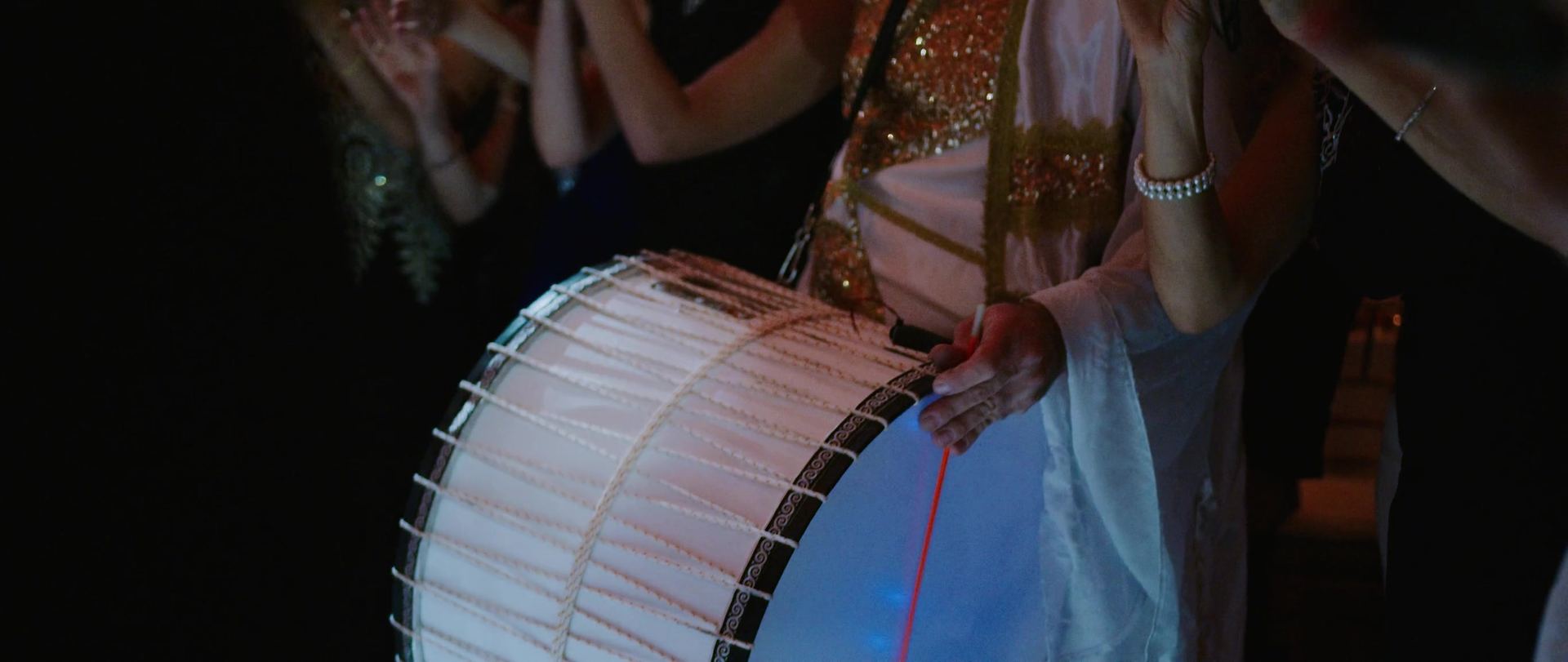 A rope-laced drum being played during the celebration.