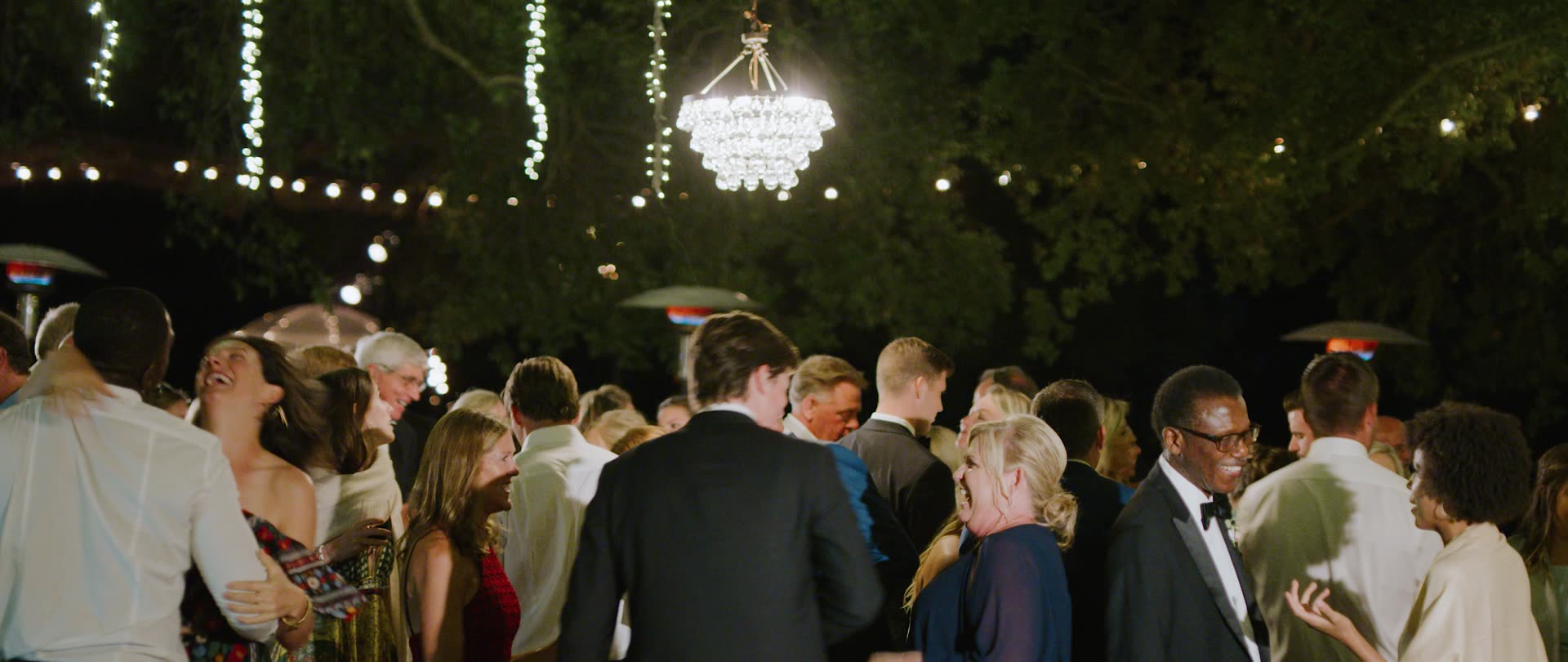 The reception under string lights after dark at Saddlerock Ranch