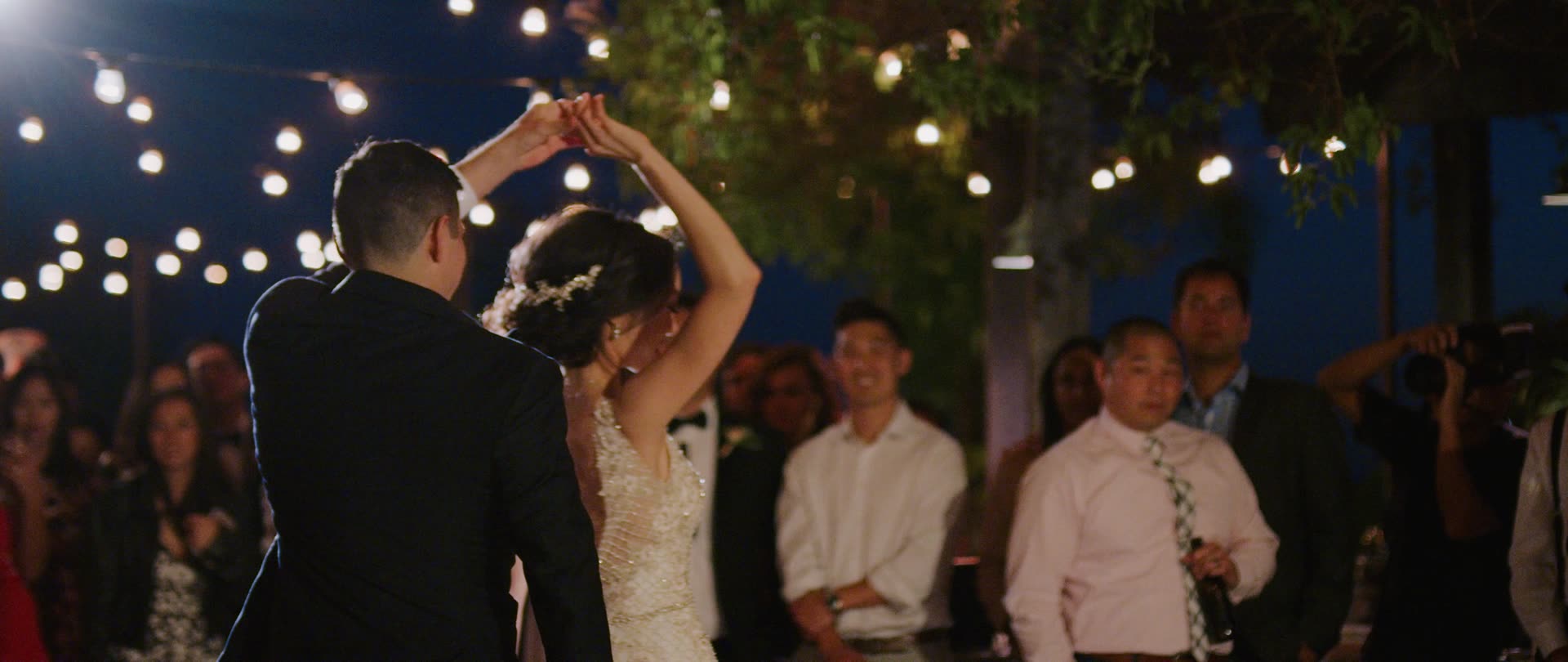 David and Liz's first dance under string lights at Villa Verano