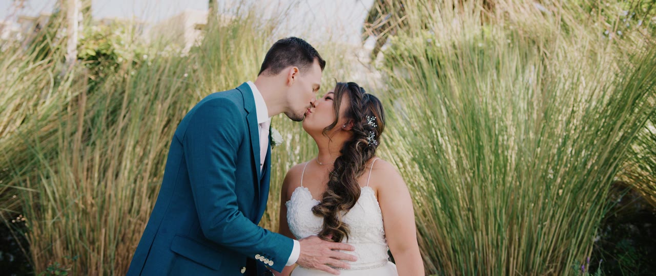 Eric and Esther kissing in the coastal grasses near the Casino San Clemente