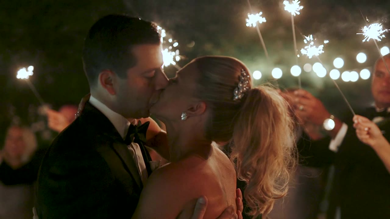 Ellen and Sandro kissing inside their sparkler exit at the Colony Palms Hotel