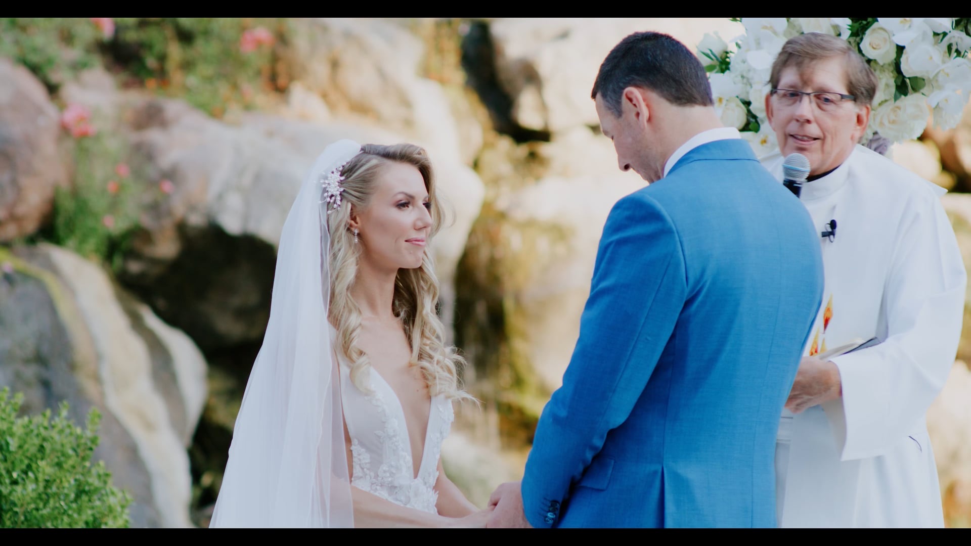 Alano and Alla exchanging vows at the waterfall ceremony site at Four Seasons Westlake Village