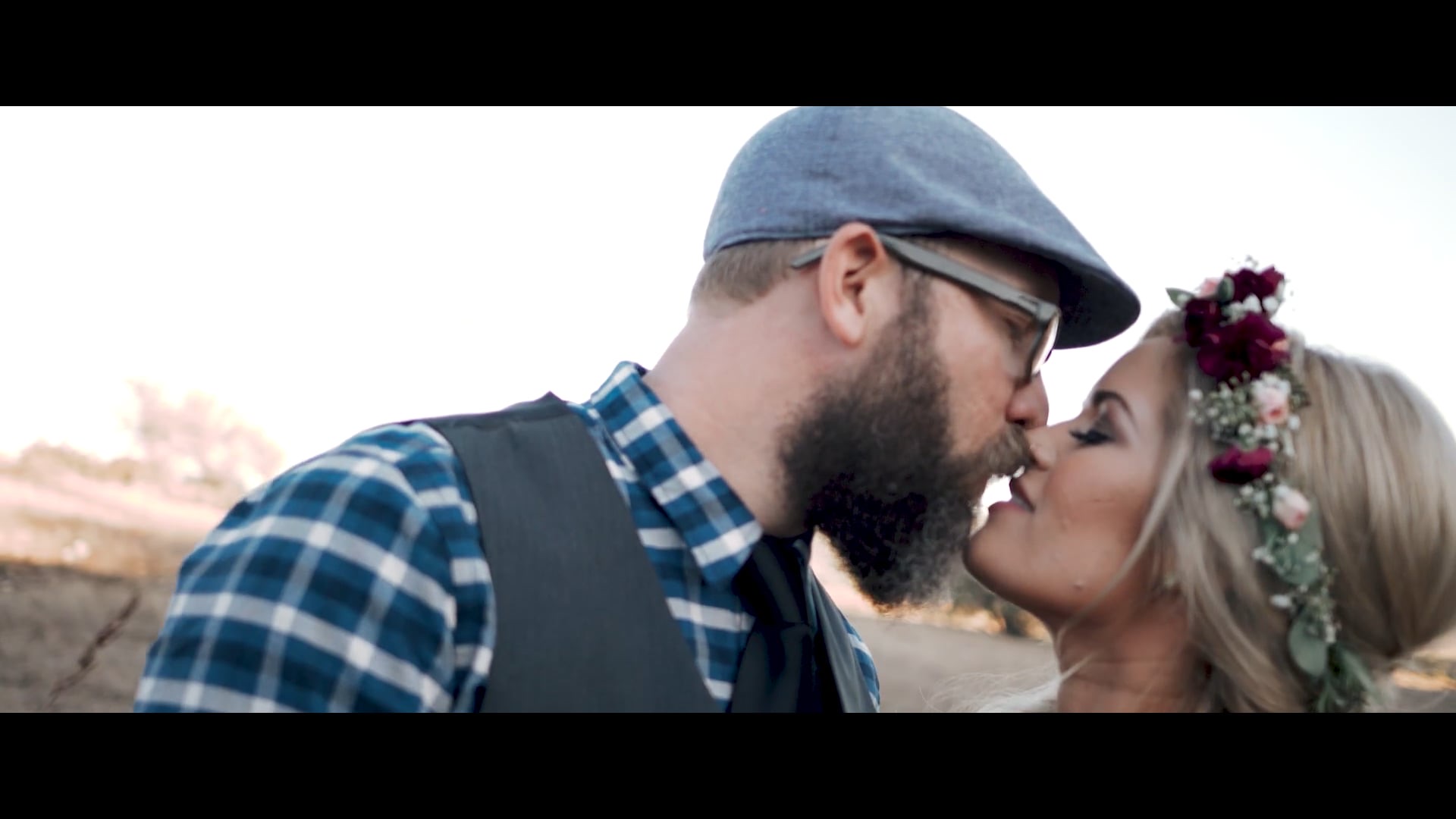 Ally and James kissing in the golden hour light at Hidden Oaks Private Weddings and Events