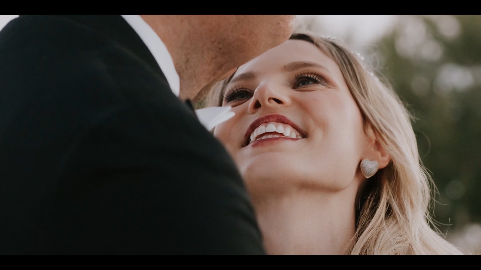 Sloane smiling up at Anthony at their wedding at Terranea Resort