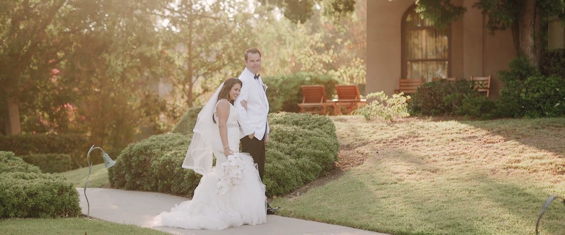 Casey and Alex on a garden path, warm low sun coming through the trees behind them