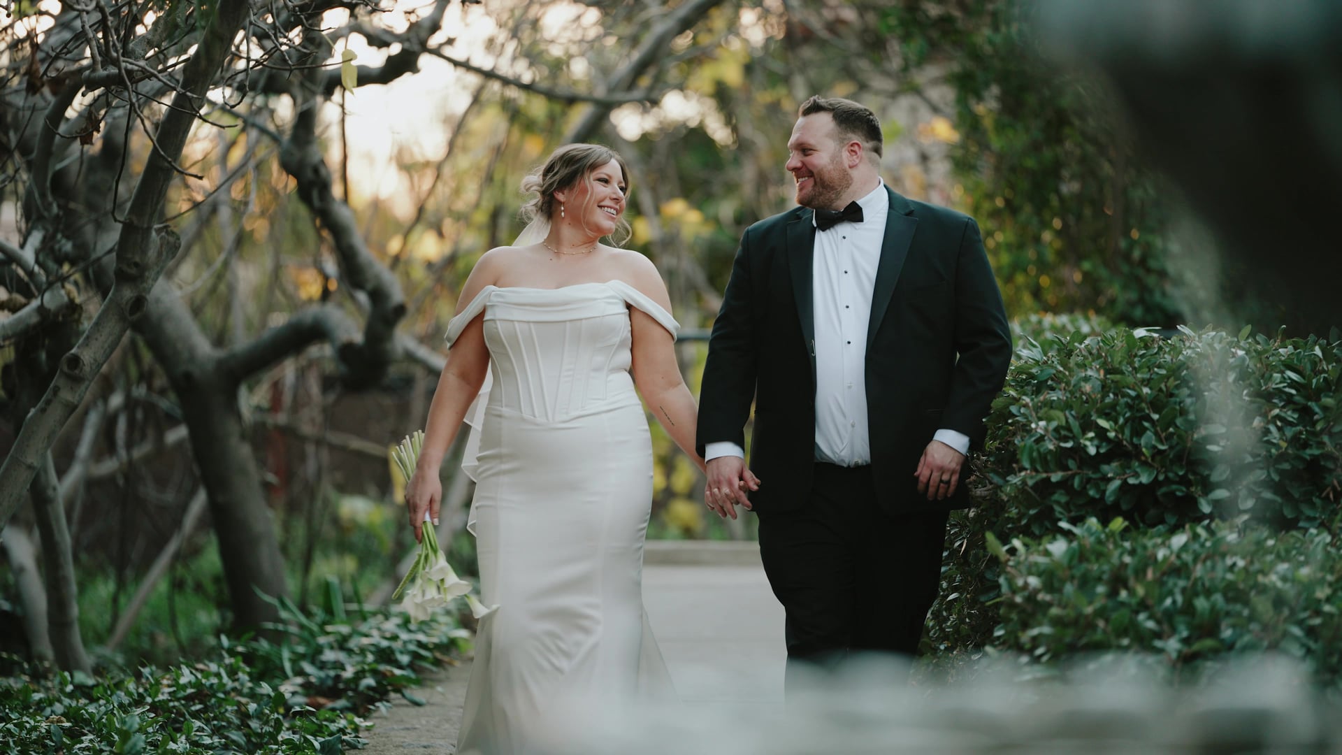 Chris and Emily walking together through the gardens at Hidden Oaks Retreat Center in the late afternoon