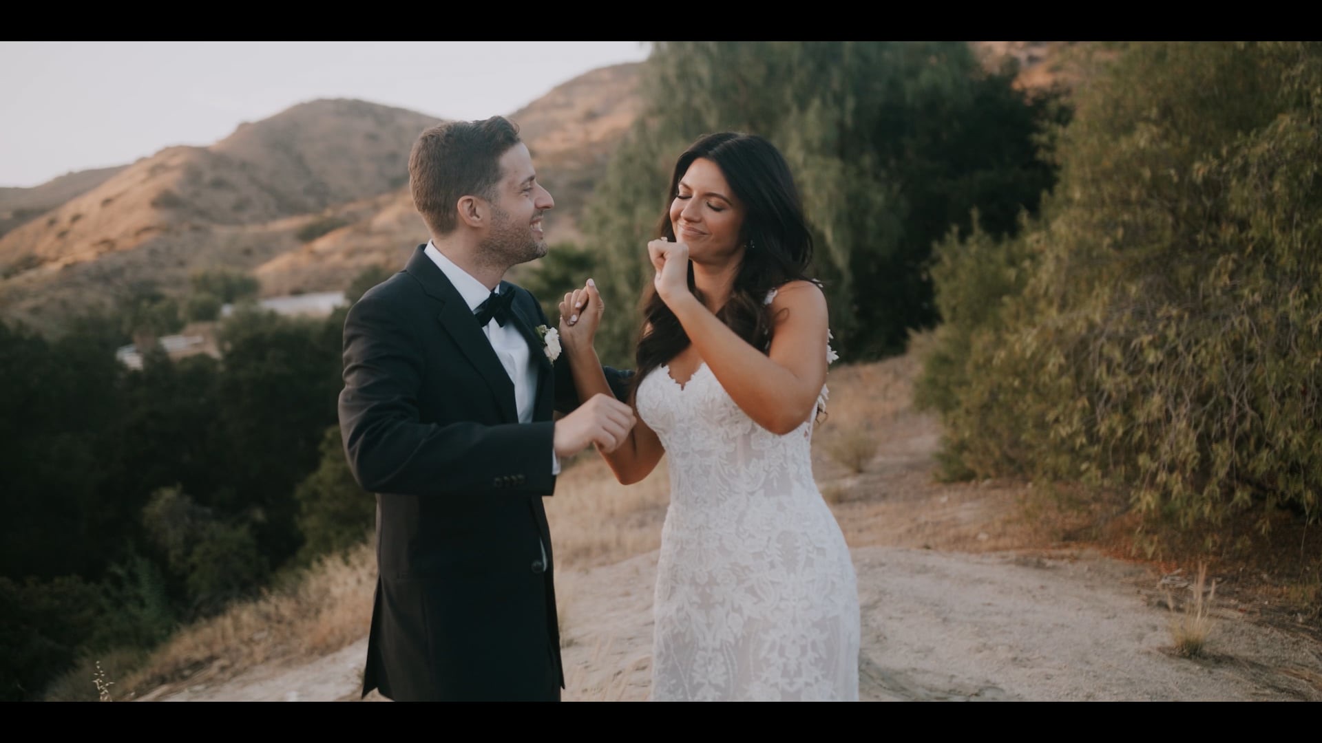 Evan and Kelly laughing together on the ridge at Hummingbird Nest Ranch
