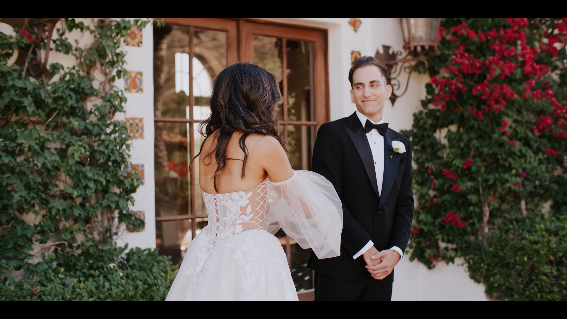 Faraz and Nassim at their Persian ceremony against the floral wall at Hummingbird Nest Ranch