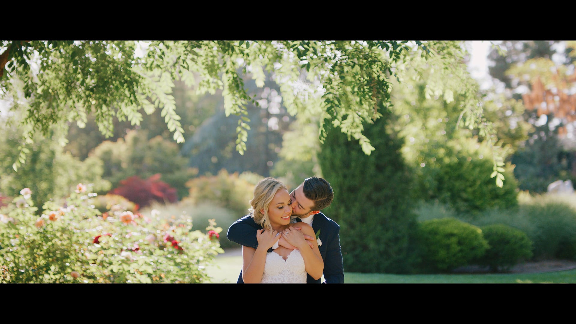 Garrison and Meredith close together among the flowering garden at Four Seasons Westlake Village