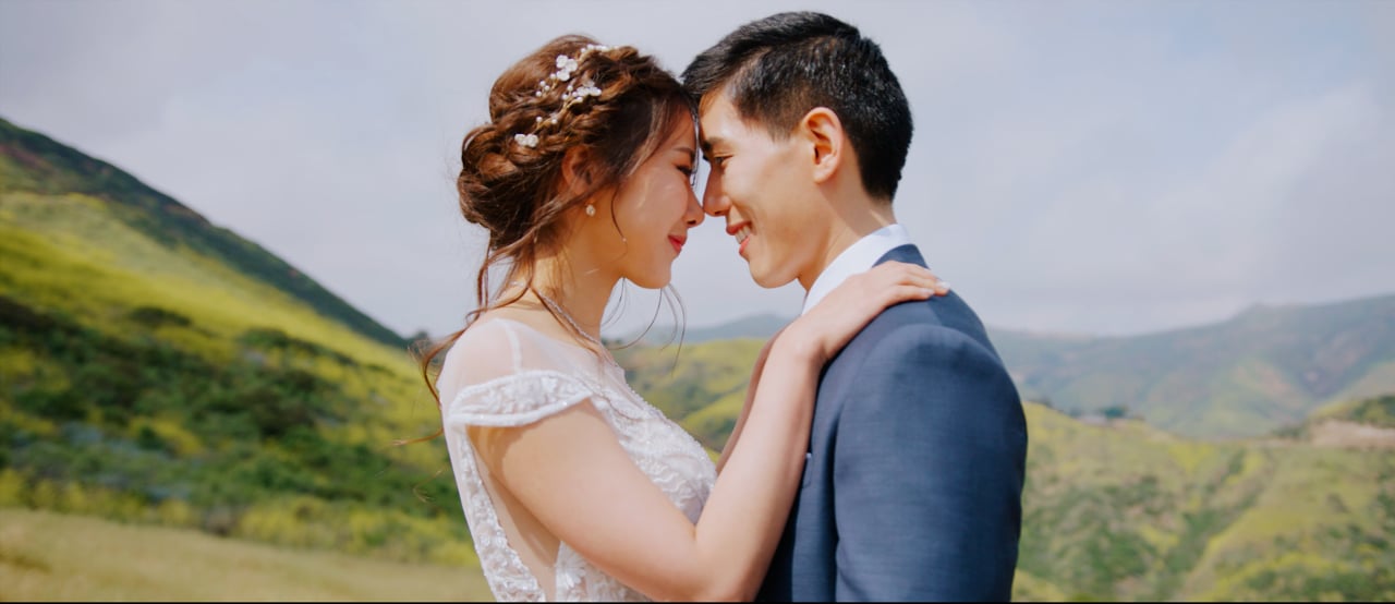 Joe and Krislyn forehead to forehead with the green Malibu hills behind them at Calamigos Ranch