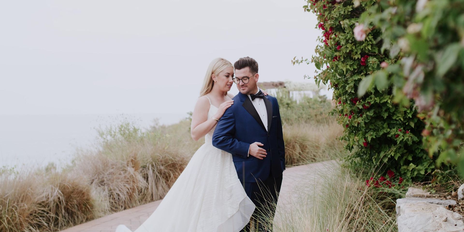 Josh and Gina together on the bluff path among the coastal grasses at Terranea Resort