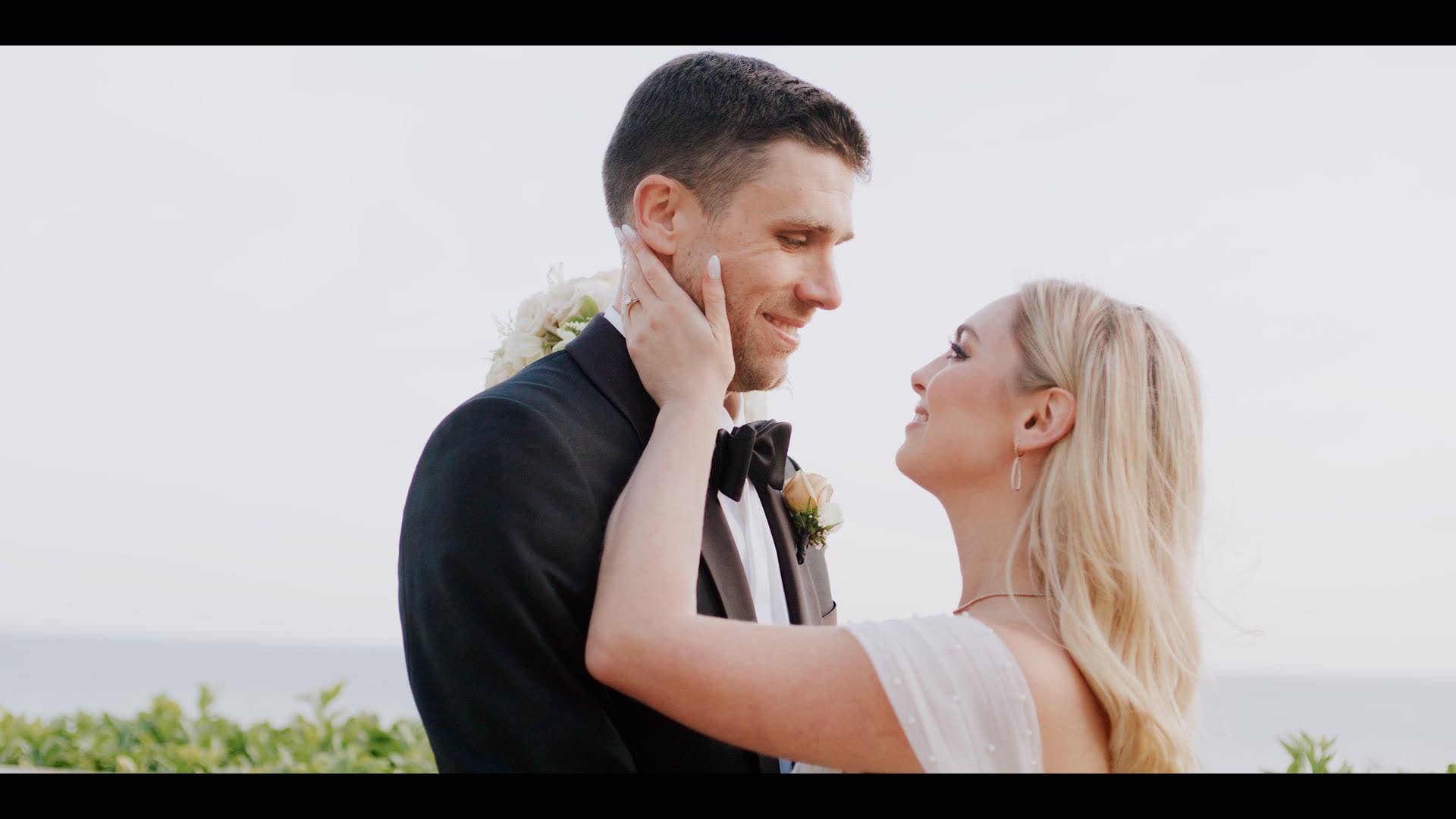 Kyle and Marissa close together above the ocean at Bel-Air Bay Club