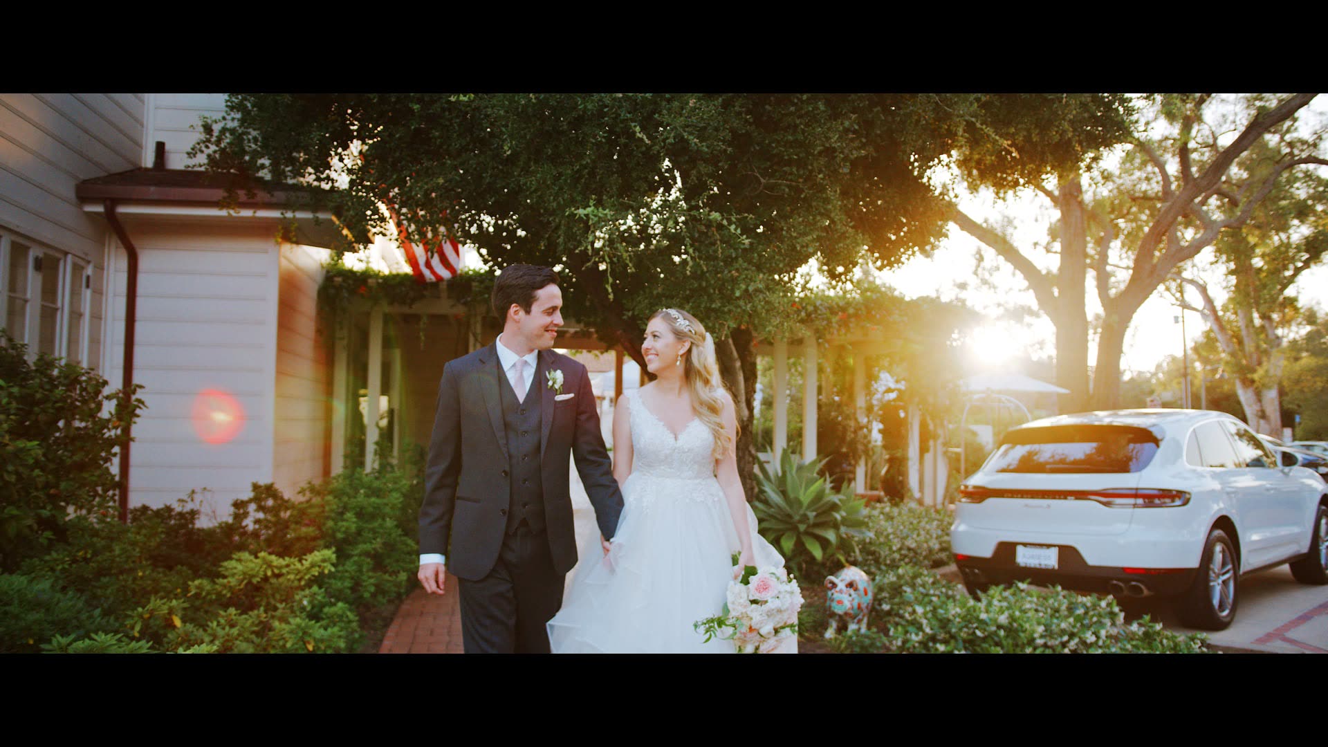 Ryan and Mandi walking the path outside a white bungalow at Belmond El Encanto