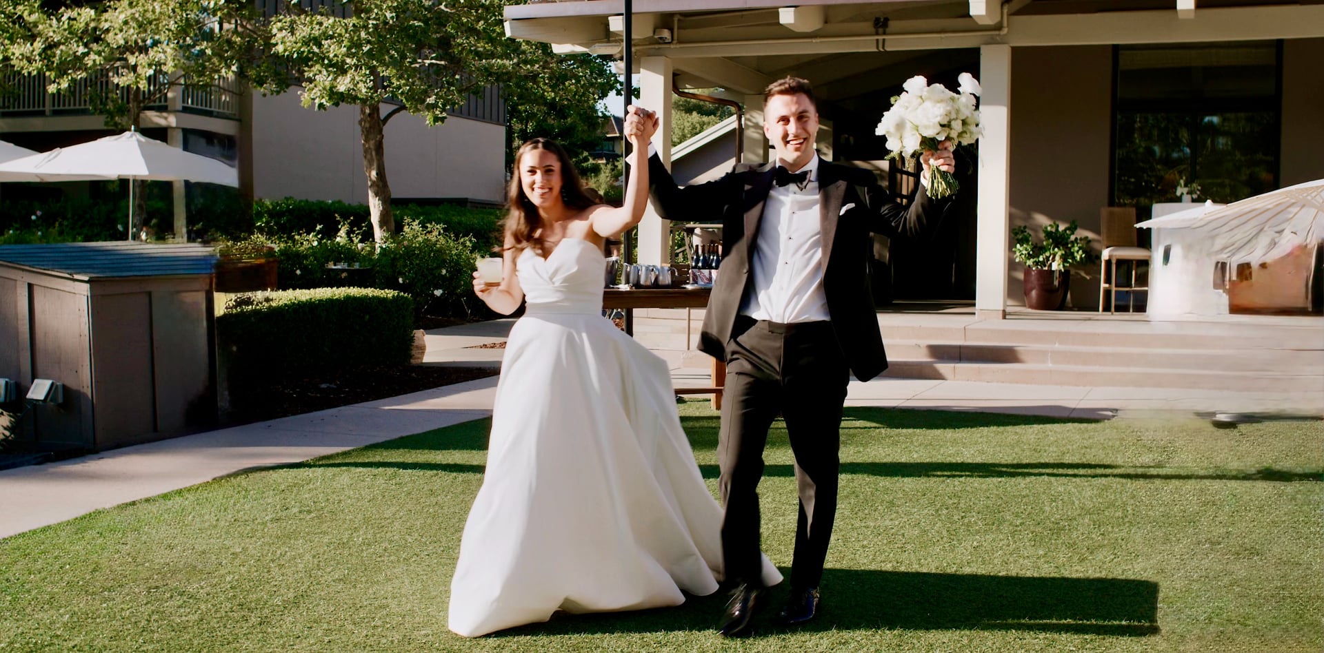 Scott and Emma celebrating on the lawn at Rosewood Sand Hill in Menlo Park, California