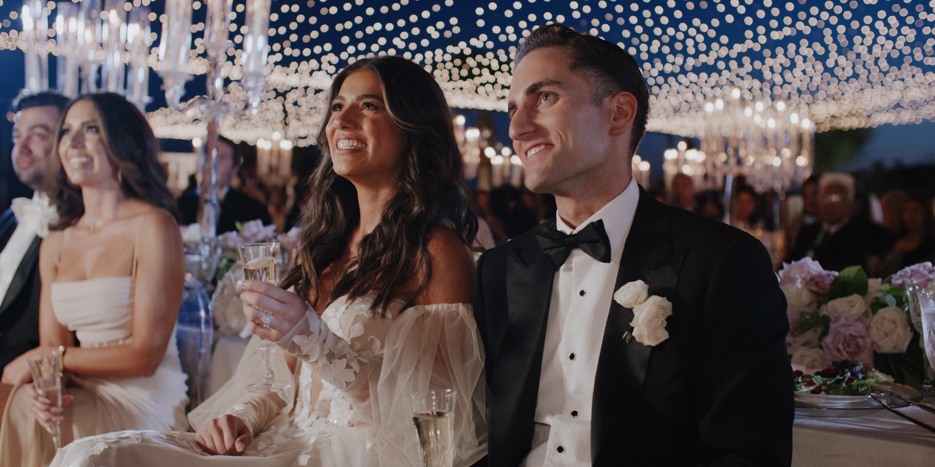Faraz and Nassim beneath a canopy of fairy lights at Hummingbird Nest Ranch