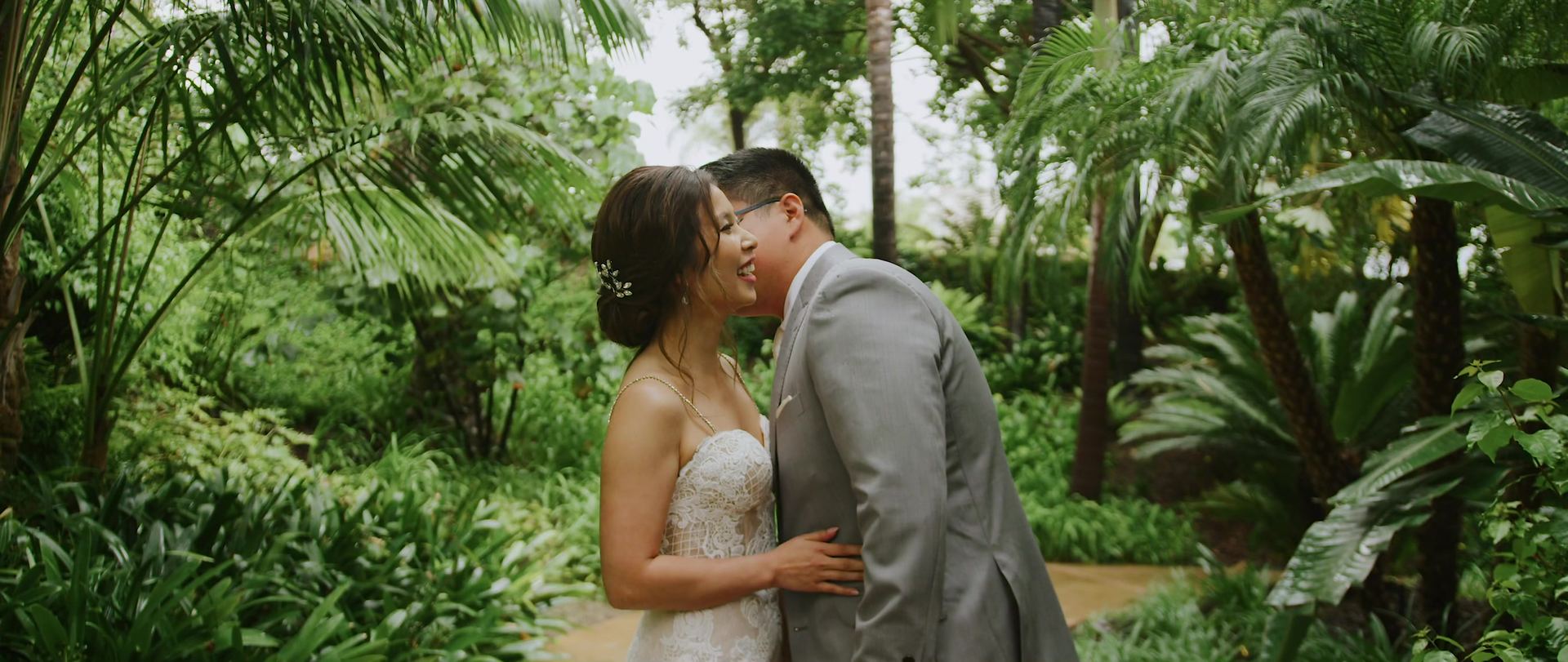 Hugo and Helen together in the tropical garden, ferns and palms closing in around them.