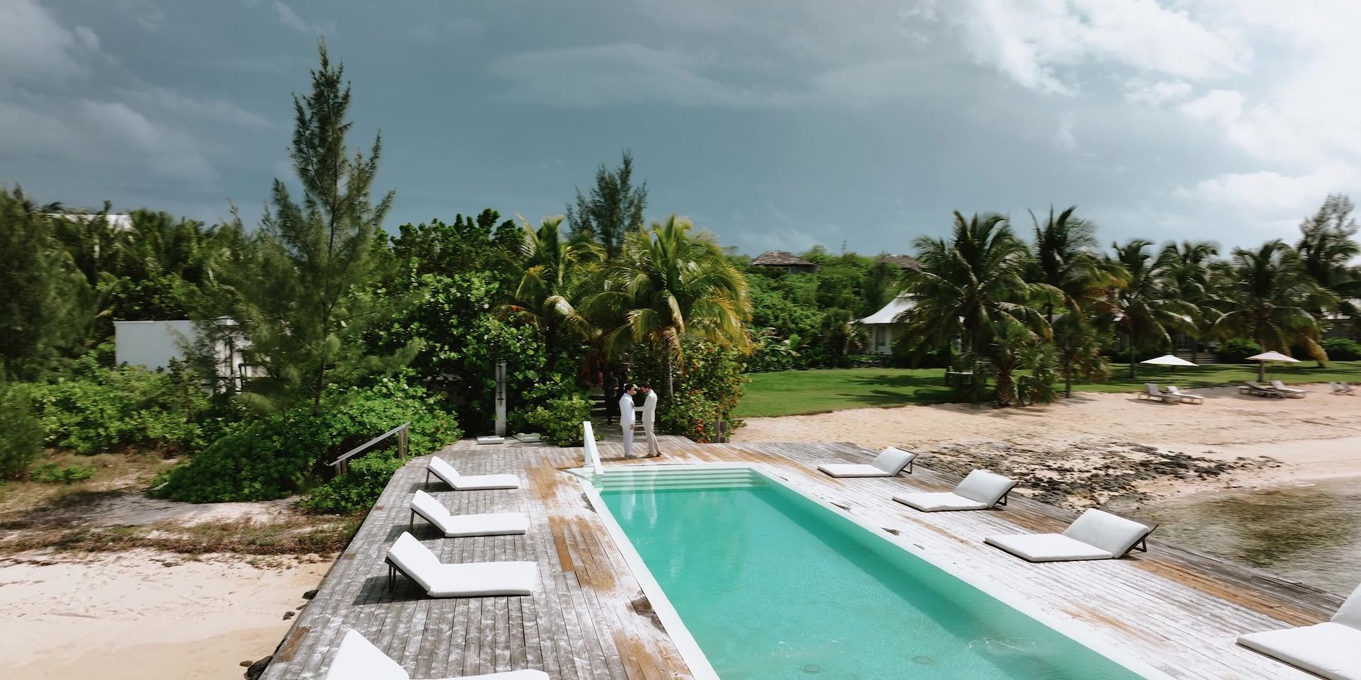 The property from above, the pool set between the lawn and the beach.