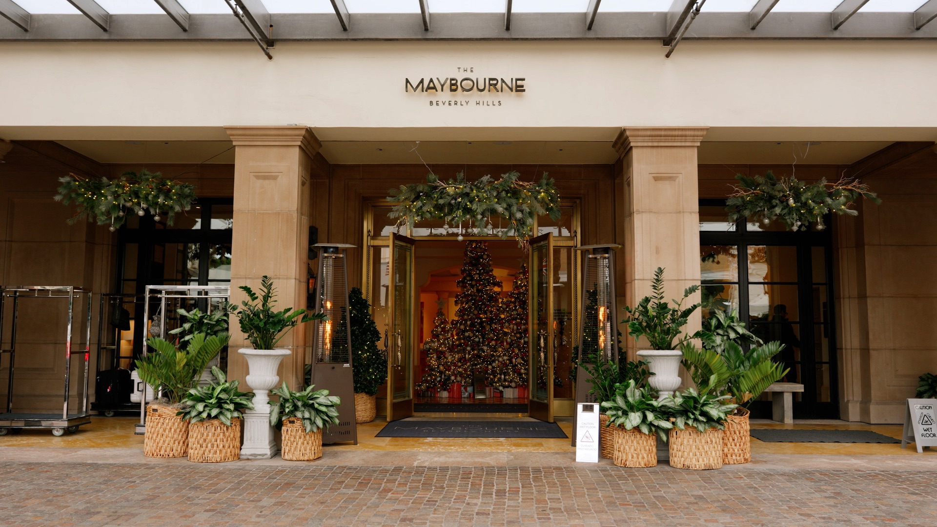 The Maybourne Beverly Hills entrance on Canon Drive, decorated with holiday garlands for a December wedding