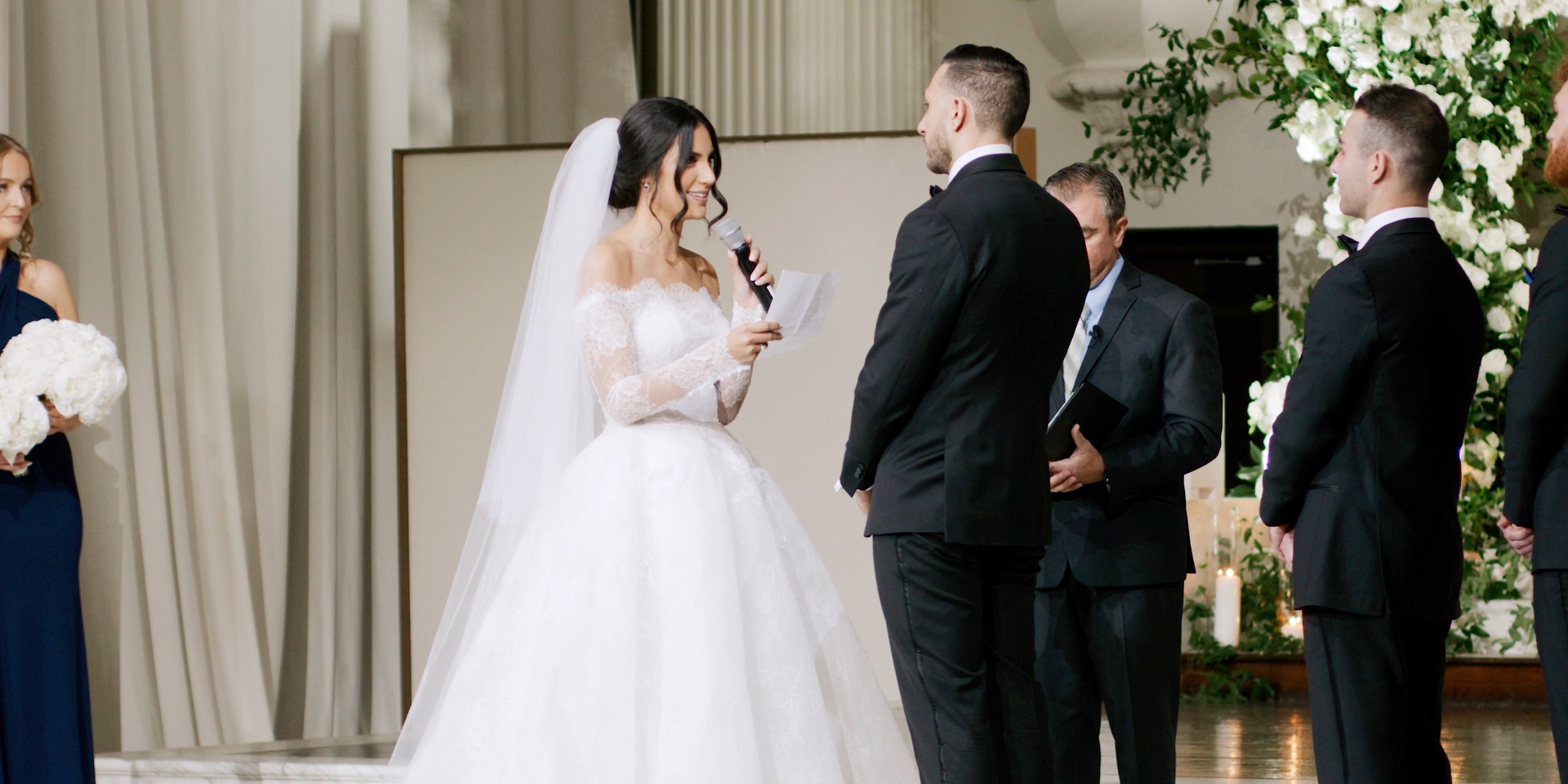 Bride reading her vows at the marble altar during a Vibiana wedding ceremony